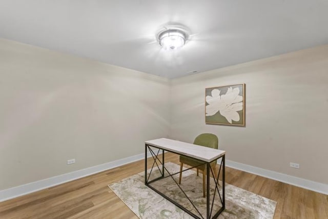office featuring baseboards and wood finished floors