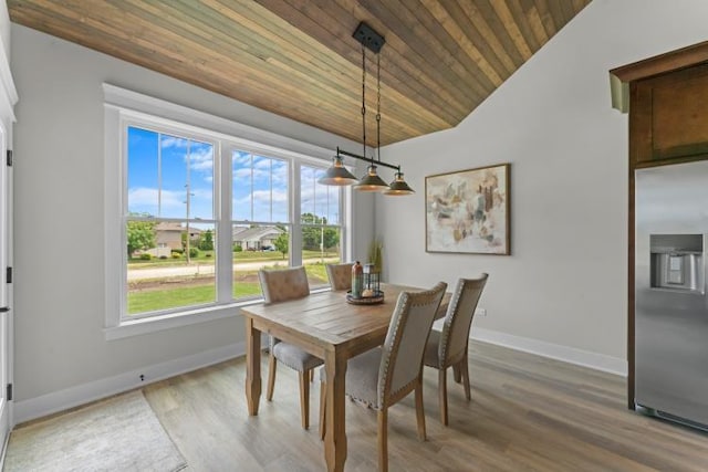 dining room with baseboards, wood ceiling, vaulted ceiling, and light wood-type flooring