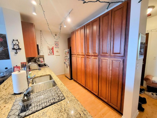 1255 S State St Unit 906, Chicago, IL 60605 - kitchen with a sink, freestanding refrigerator, light stone countertops, and light wood-style flooring