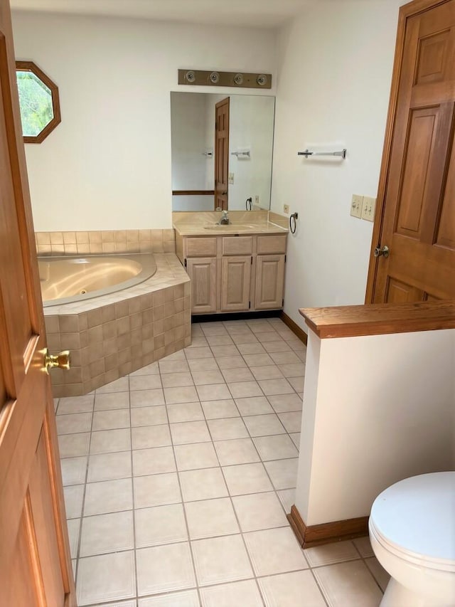 bathroom featuring vanity, toilet, tile patterned flooring, and a garden tub