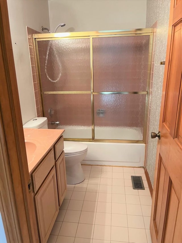 bathroom with tile patterned flooring, vanity, toilet, enclosed tub / shower combo, and visible vents