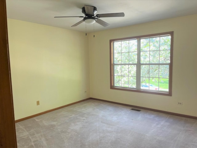 unfurnished room with baseboards, visible vents, light carpet, and a healthy amount of sunlight