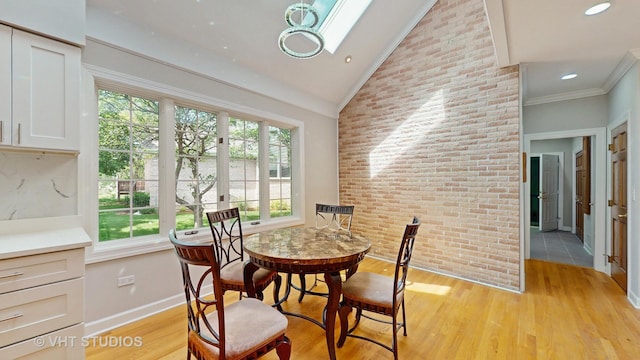8980 N Enclave Dr, Burr Ridge, IL 60527 - dining room featuring light wood-style floors, lofted ceiling, baseboards, ornamental molding, and brick wall