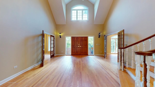 8980 N Enclave Dr, Burr Ridge, IL 60527 - foyer entrance with high vaulted ceiling, light wood-style flooring, stairs, and baseboards