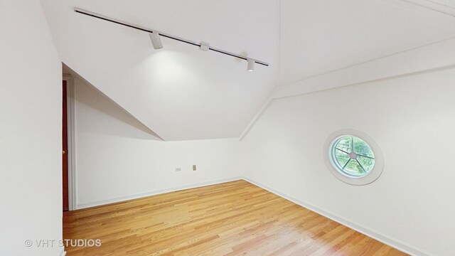 8980 N Enclave Dr, Burr Ridge, IL 60527 - bonus room with lofted ceiling, wood finished floors, and baseboards