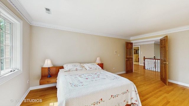 8980 N Enclave Dr, Burr Ridge, IL 60527 - bedroom with light wood finished floors, crown molding, and baseboards