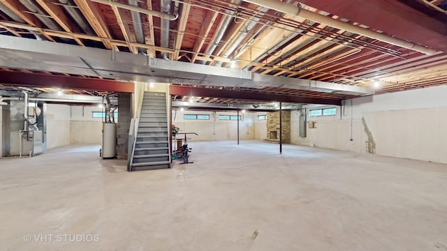 8980 N Enclave Dr, Burr Ridge, IL 60527 - below grade area featuring heating unit, gas water heater, stairway, and electric panel