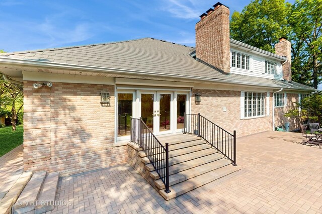 8980 N Enclave Dr, Burr Ridge, IL 60527 - rear view of house with french doors, a chimney, a patio area, and brick siding