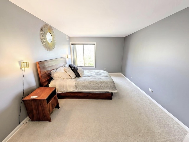 bedroom with carpet floors and baseboards