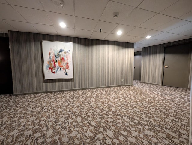 finished below grade area featuring baseboards, carpet flooring, recessed lighting, and a paneled ceiling
