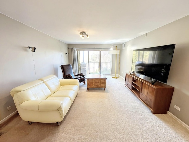living room with light colored carpet and baseboards
