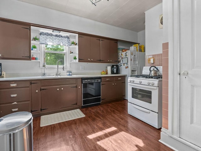 kitchen with dishwasher, gas range gas stove, a sink, dark wood-type flooring, and light countertops