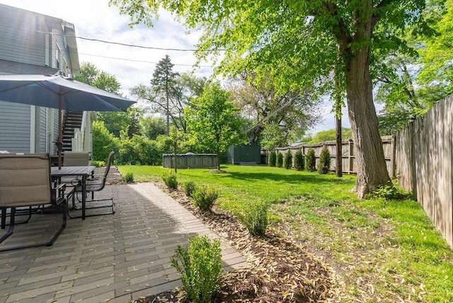 view of yard featuring outdoor dining area and a patio