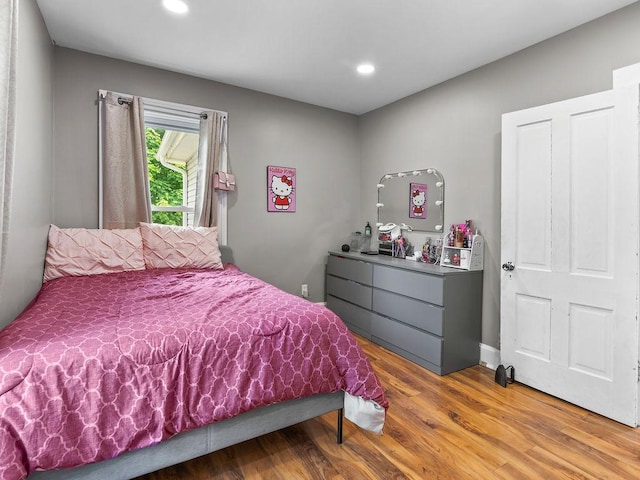 bedroom with wood finished floors and recessed lighting