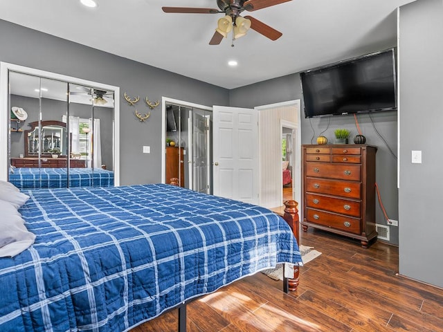 bedroom with multiple closets, wood finished floors, recessed lighting, and a ceiling fan