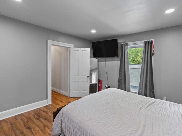 bedroom featuring baseboards, recessed lighting, and wood finished floors