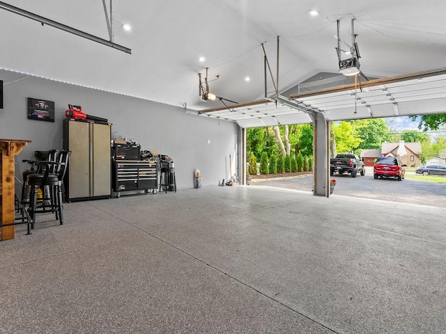 garage with a garage door opener and recessed lighting