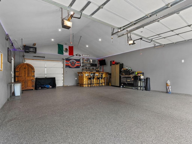 garage featuring a garage door opener and a workshop area