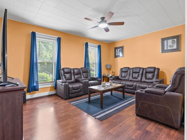 living area featuring ceiling fan, healthy amount of natural light, and dark wood-style floors