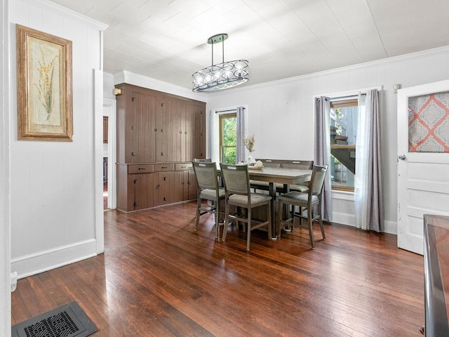 dining space with ornamental molding, dark wood-style flooring, and baseboards