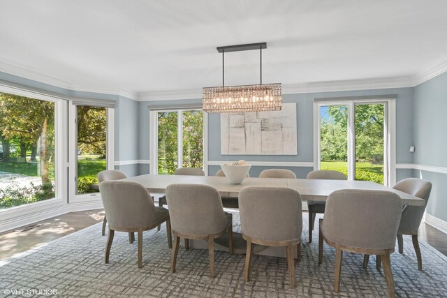 5632 Oakwood Cir, Long Grove, IL 60047 - dining space featuring a chandelier, plenty of natural light, and crown molding