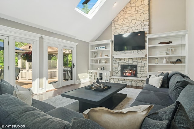 5632 Oakwood Cir, Long Grove, IL 60047 - living room with a skylight, high vaulted ceiling, a stone fireplace, wood finished floors, and baseboards