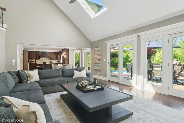 5632 Oakwood Cir, Long Grove, IL 60047 - living room featuring high vaulted ceiling, wood finished floors, baseboards, a skylight, and a ceiling fan