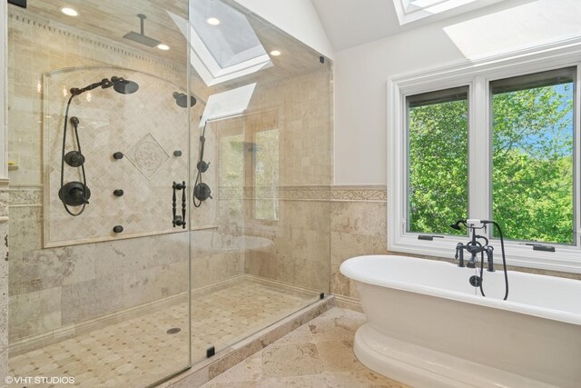5632 Oakwood Cir, Long Grove, IL 60047 - bathroom with healthy amount of natural light, a skylight, a shower stall, a soaking tub, and tile walls