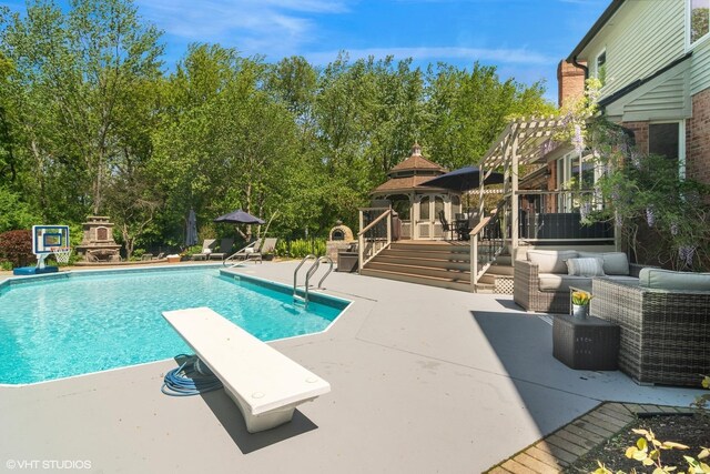 5632 Oakwood Cir, Long Grove, IL 60047 - swimming pool with a patio area, a diving board, a gazebo, an outdoor living space, and view of scattered trees