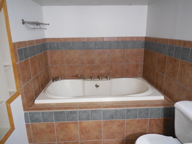 full bathroom with toilet and a garden tub