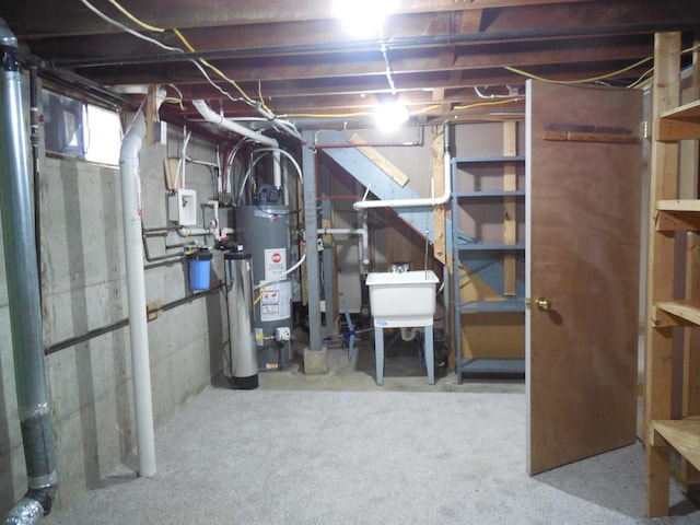 below grade area featuring a sink and water heater