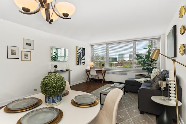 dining area featuring a chandelier, baseboards, and a city view