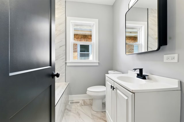 bathroom with a wealth of natural light, visible vents, marble finish floor, and vanity