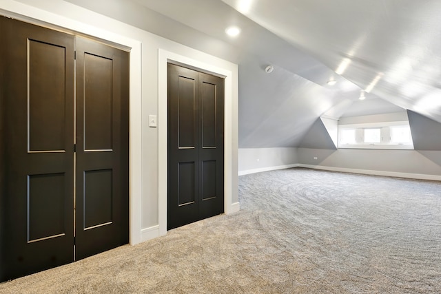 additional living space with lofted ceiling, carpet floors, and baseboards