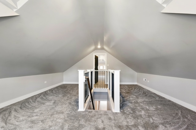 additional living space with vaulted ceiling, carpet floors, and baseboards