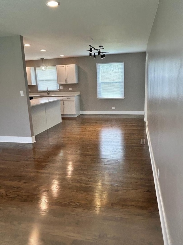 607 W Maude Ave, Arlington Heights, IL 60004 - unfurnished living room with baseboards, dark wood-style flooring, recessed lighting, and a chandelier
