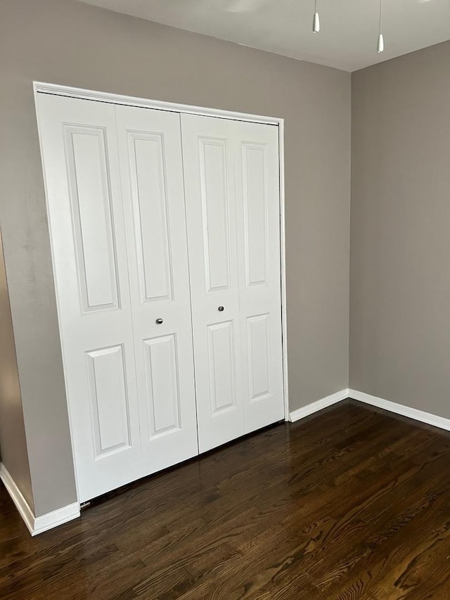 607 W Maude Ave, Arlington Heights, IL 60004 - unfurnished bedroom featuring dark wood-type flooring, baseboards, and a closet