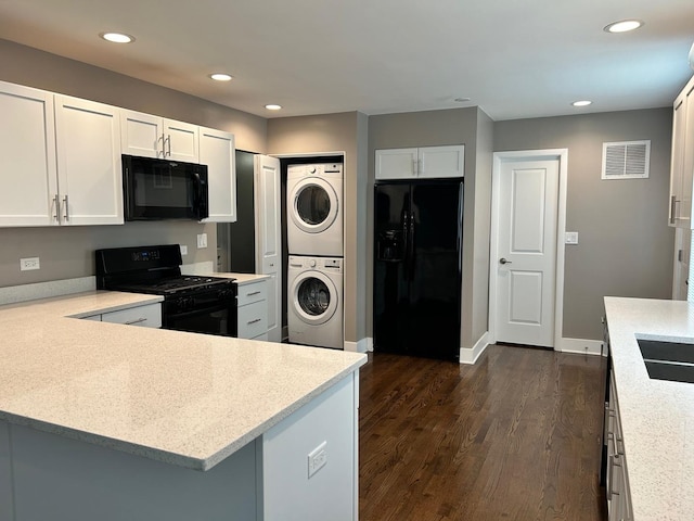 607 W Maude Ave, Arlington Heights, IL 60004 - kitchen with black appliances, stacked washing machine and dryer, dark wood finished floors, light countertops, and recessed lighting