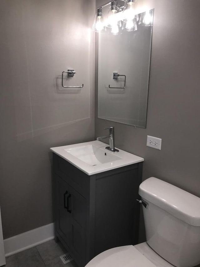 607 W Maude Ave, Arlington Heights, IL 60004 - half bathroom featuring toilet, vanity, tile patterned floors, and baseboards