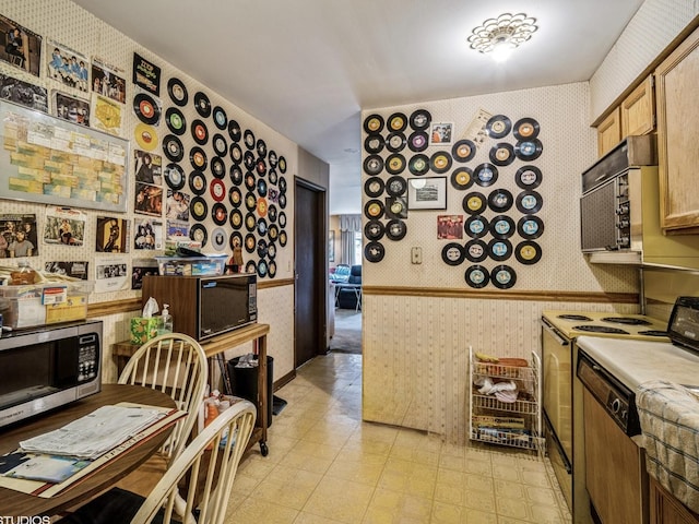 9622 Bianco Ter Unit D, Des Plaines, IL 60016 - kitchen with wallpapered walls, white range with electric cooktop, stainless steel microwave, light countertops, and black microwave