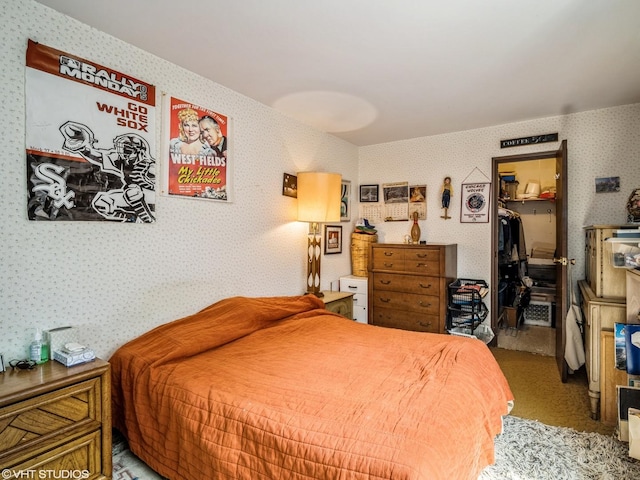 9622 Bianco Ter Unit D, Des Plaines, IL 60016 - bedroom featuring wallpapered walls, a walk in closet, carpet, and a closet