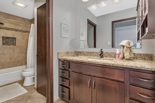 bathroom with tile patterned floors, toilet, vanity, and shower / bath combination with curtain
