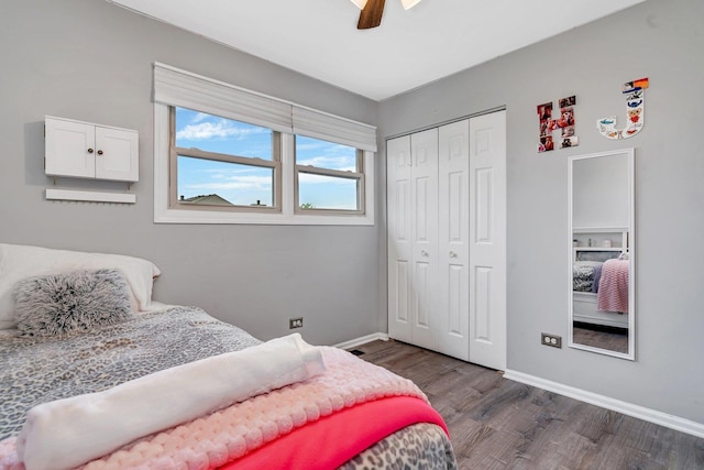bedroom with a closet, baseboards, a ceiling fan, and dark wood-style floors