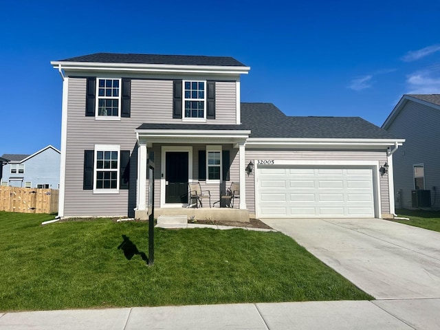 traditional-style home with a garage, fence, a front yard, concrete driveway, and a porch