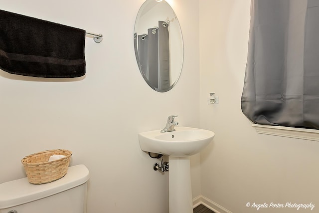 half bathroom featuring toilet