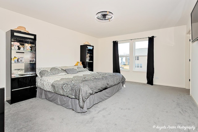 bedroom with baseboards and carpet