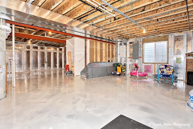 basement with water heater and electric panel