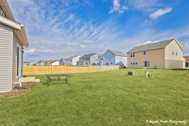 view of yard with fence and a residential view