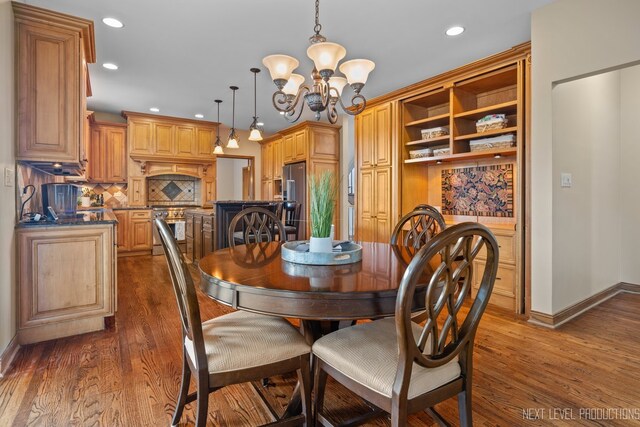 dining space featuring a chandelier, recessed lighting, baseboards, and dark wood finished floors