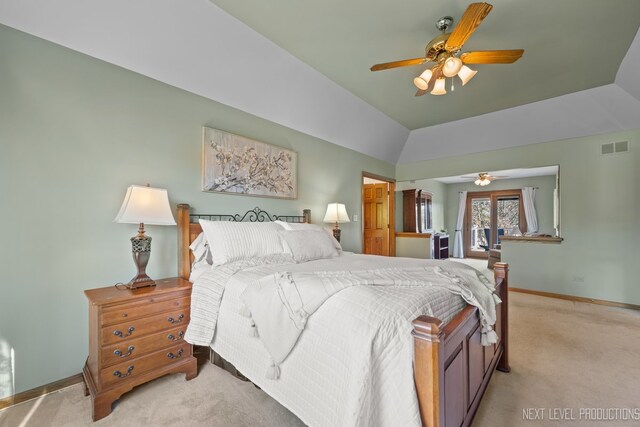 bedroom featuring light colored carpet, baseboards, lofted ceiling, and a ceiling fan